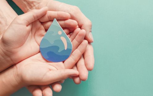 Adult and child hands holding paper cut water drop, World Water Day,  Clean water and sanitation, CSR, save water,  ecology concept  